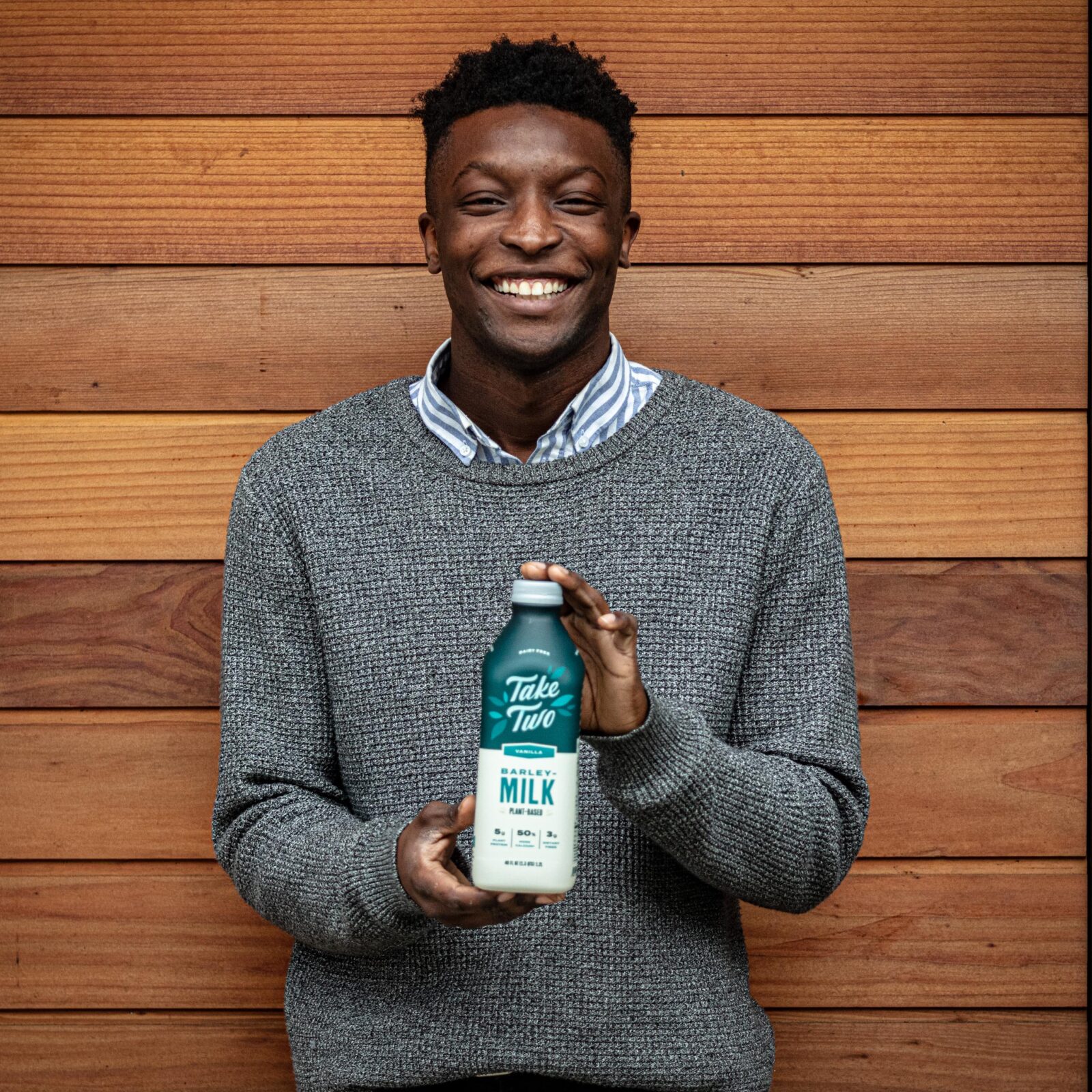 Man holding Vanilla Take Two bottle